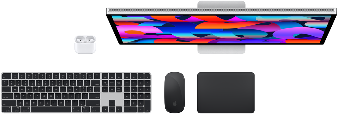 Top view of Mac accessories: Studio Display, AirPods, Magic Keyboard, Magic Mouse, and Magic Trackpad